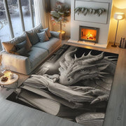 Charcoal fantasy dragon resting its head and claws on an open spellbook beside a candle in an ancient library area rug. - thumbnail image 5 of 8