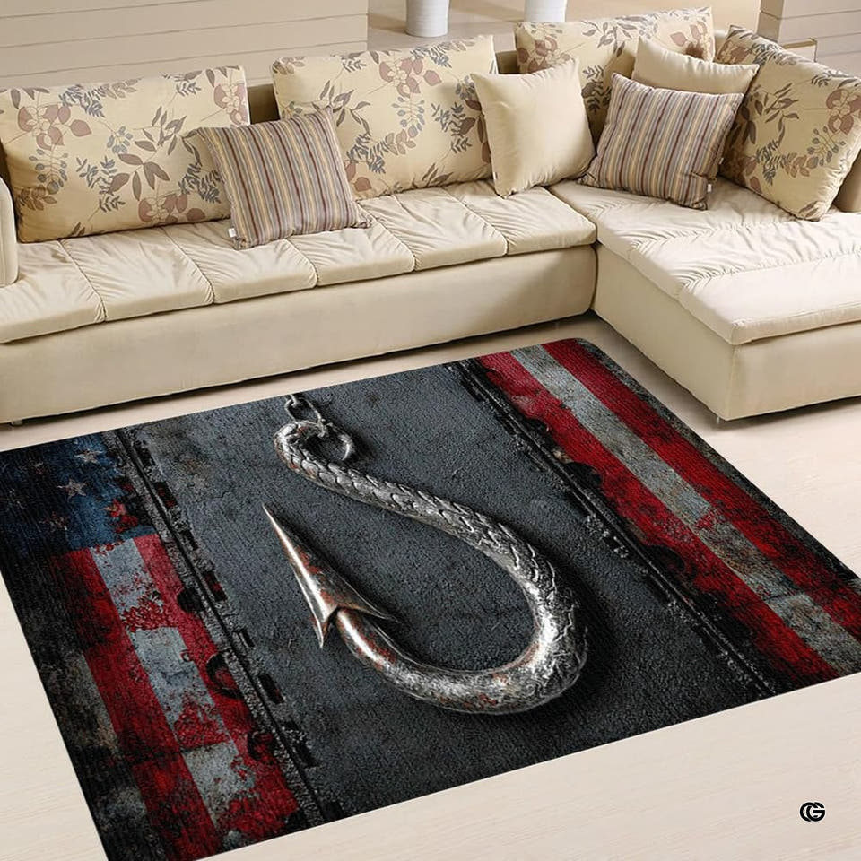 Patriotic fish hook area rug displaying weathered flag graphics centered in front of a sofa.