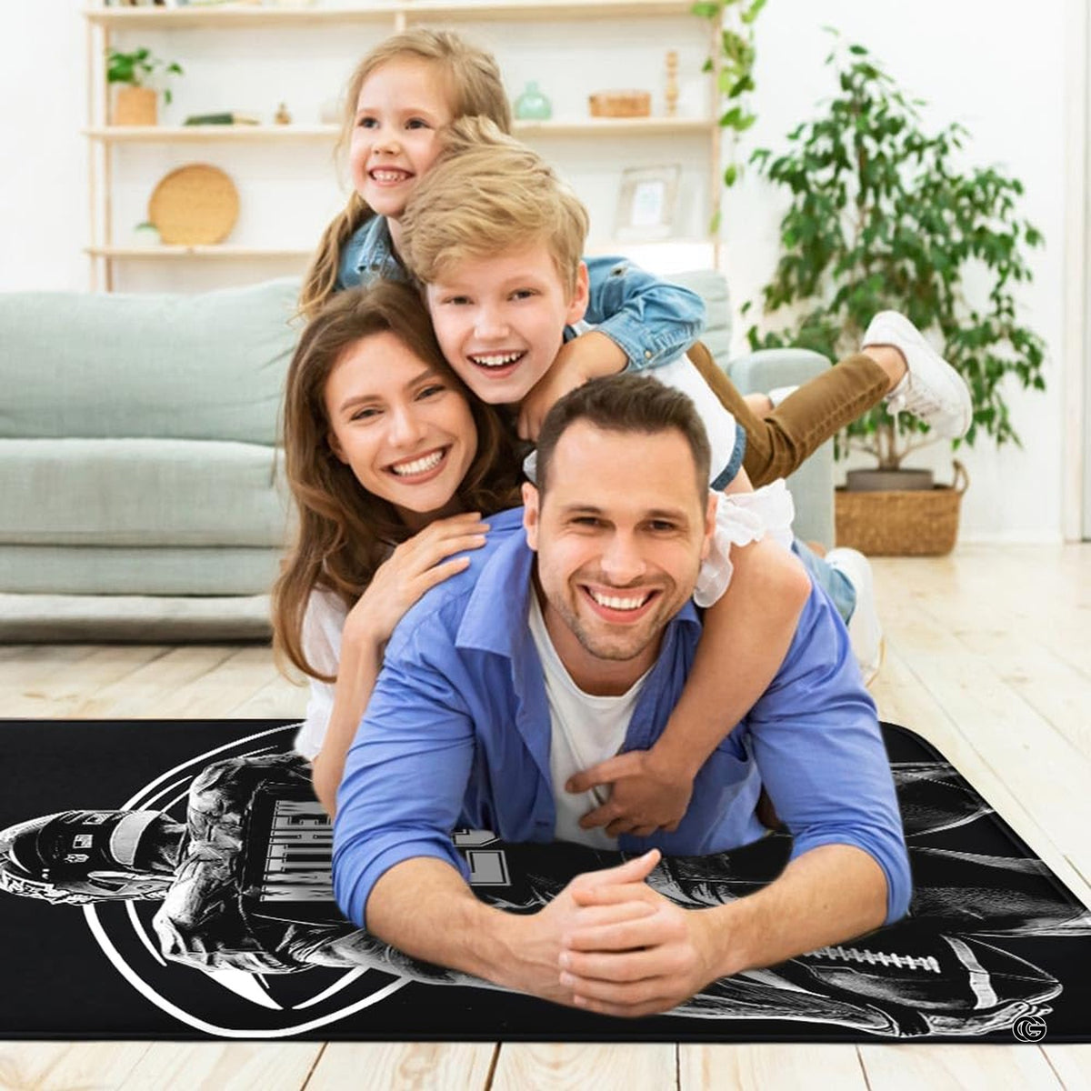 Sports fan cave layout displaying the monochrome football player rug on hardwood flooring - image 5 of 7