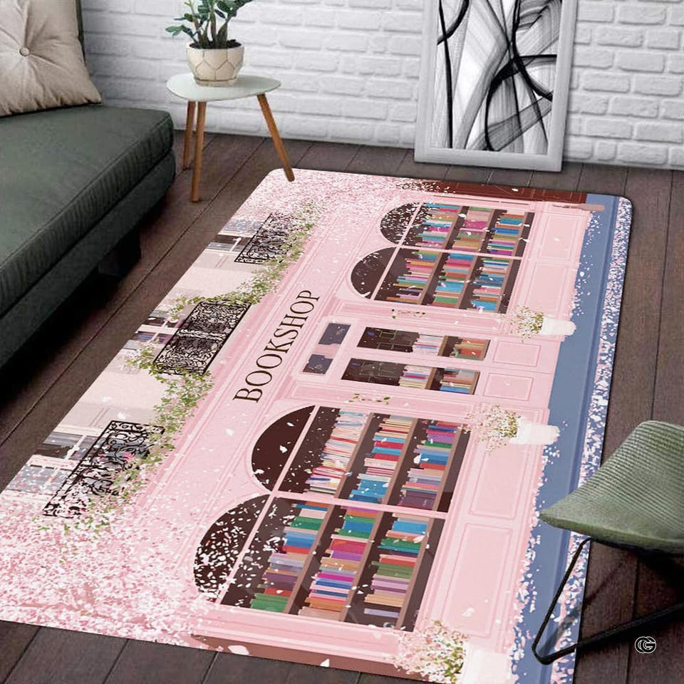Pastel pink storefront area rug with arched windows and blossom petals on dark wood flooring.