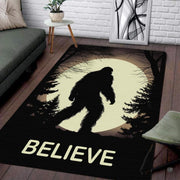 Bigfoot silhouette walking through a pine forest under a glowing full moon on an area rug. - thumbnail image 1 of 5