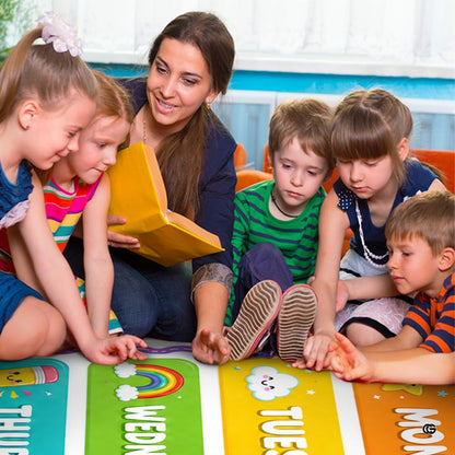 Educational calendar rug positioned beside white storage cubbies and decorative wooden playroom furniture. - thumbnail image 5 of 7